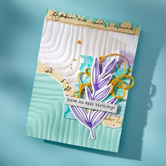 Sample of artwork created using Lined Corners 3D Embossing Folder and other spellbinders products designed by Dina Wakley MEdia. Part of the 'Modern Botanicals' collection made by Spellbinders Paper Arts (no.E3D-124). The embossing folder is A5 in size (145mm x 223mm). What a wonderful way to add stylized texture and patterns into shapes, backgrounds and collaged layers. This design features 4 corners with parallel lines within each corner, made of raised rounded thickish lines. Image of a birthday card.