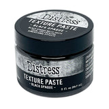 Black Texture Paste - Tim Holtz Distress Dimensional Medium with solid black coverage and matte finish, 3fl oz (88.7ml) jar. Made by Ranger.  Tim Holtz Distress Texture Paste in Black is a dimensional medium that dries as you place it, with all the marks, peaks and effects you create. It is smooth dark sooty black medium which dries to an opaque (black) matte finish that is flexible and can be stained, die cut, trimmed, sanded, painted, or altered.