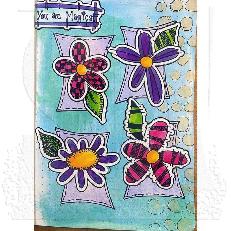 A square handmade art journal page featuring four colorful, hand-drawn flower stickers on lavender rectangular backing cards. The page has a light blue watercolor wash background with hand-drawn gold circles and a purple banner at the top that reads 'You are Magical'.
