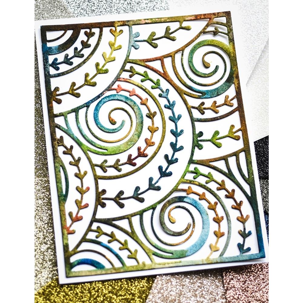 Curlicue Plate - Die Cutting Template by Memory Box (no. MB94698). Spirals and arrows curling and overlapping. Design size 4" x 5 1/4" (10.2cm x 13.3cm). 1 (one) template. This gorgeous design features overlapping spirals of curls and arrows in fine lines, perfect for layering and adding dimension for cards, scrapbook pages, journaling, mixed media of all kinds. Photo of the beautiful rustic rainbow cutout.