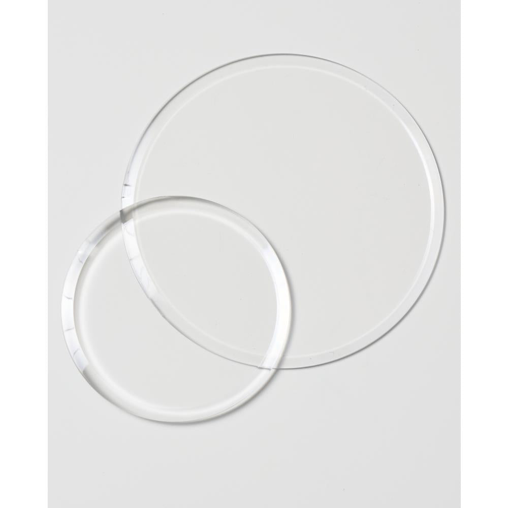 Clear Cutting Pads, Round, 2 Sizes ... by Sizzix. Clear circular plastic cutting plates to use with Sizzix die cutting templates and embossing folders. Sizes approx 5" x 5" (127mm in diameter) and 3 1/2" x 3 1/2" (88mm in diameter), each is 3mm thick (one of each size). This pack of Sizzix Cutting Pads includes a wonderful pair of round discs, circular cutting plates to use in your die cutting adventures. Photo of the 2 discs.