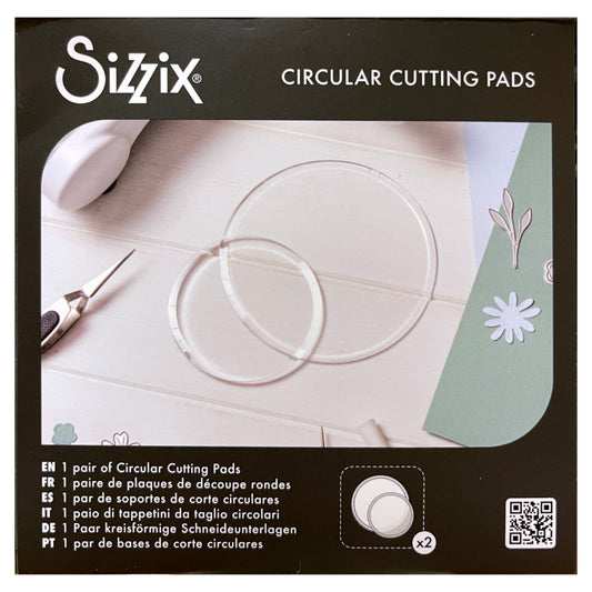 Clear Cutting Pads, Round, 2 Sizes ... by Sizzix. Clear circular plastic cutting plates to use with Sizzix die cutting templates and embossing folders. Sizes approx 5" x 5" (127mm in diameter) and 3 1/2" x 3 1/2" (88mm in diameter), each is 3mm thick (one of each size). This pack of Sizzix Cutting Pads includes a wonderful pair of round discs, circular cutting plates to use in your die cutting adventures. Photo of the packaging showing 2 discs.