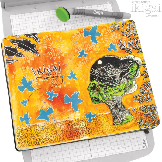 Ikigai - Stencils and Stamps ... Sizzix Studio Mixed Media Kit ... by Cat Kerr and Sizzix. Layering art stencils and clear acrylic stamps to use for mixed media, papercrafts, art journaling, visual arts of all kinds. Beautiful mountain and river scene within a face, flying flocks of birds, mandala patterns, leaves and more. Photograph of an example by Cat Kerr.