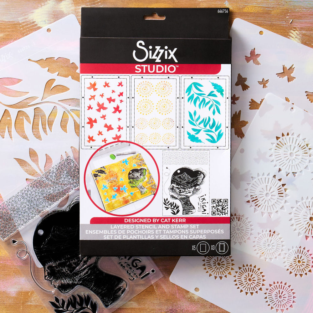 Ikigai - Stencils and Stamps ... Sizzix Studio Mixed Media Kit ... by Cat Kerr and Sizzix. Layering art stencils and clear acrylic stamps to use for mixed media, papercrafts, art journaling, visual arts of all kinds. Beautiful mountain and river scene within a face, flying flocks of birds, mandala patterns, leaves and more. Photograph of the packaging.
