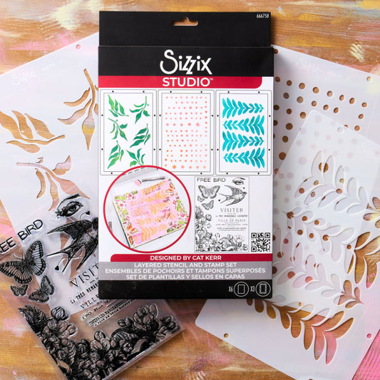 The Visitor - Stencils and Stamps ... Sizzix Studio Mixed Media Kit ... by Cat Kerr and Sizzix. Layering art stencils and clear acrylic stamps to use for mixed media, paper crafts, art journaling, visual arts of all kinds. Designs feature a flying bird (swallow), an eye, text, butterflies, flowers and leafy patterns. Photo of the packaging.