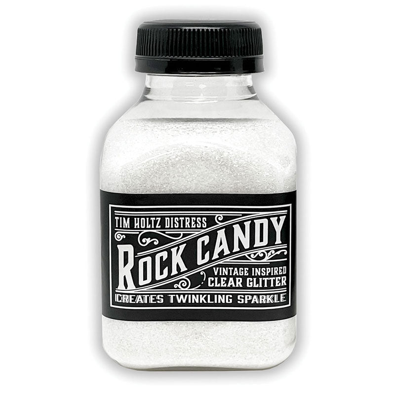 Clear - Rock Candy Distress Dry Glitter - by Tim Holtz and Ranger ... A crystal clear, light sparkly multi-sized fine glitter. Jar contains 4.7oz (133g) jar.
Tim's 'Clear' Distress Dry Glitter is a vintage inspired, multi-sized fine translucent glitter which creates twinkling sugary sparkle everywhere you go.