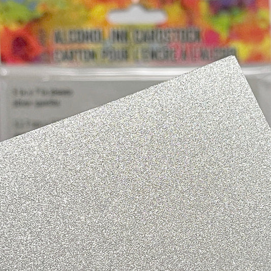 Photo of Silver Sparkle Cardstock - by Tim Holtz and Ranger ... a cool silver coloured cardstock with a subtle shine and sparkly effect with a smooth finish. Ideal as a base for alcohol ink painting or marbling, using for embossing, cardmaking, die cutting, mixed media and creative papercrafts. 10 (ten) sheets, 5" x 7" (127mm x 177mm) in size.
Tim Holtz Silver Sparkle Alcohol Ink Sheets are rectangle pieces of shimmering silver coated cardstock to use with Tim Holtz and Ranger alcohol inks