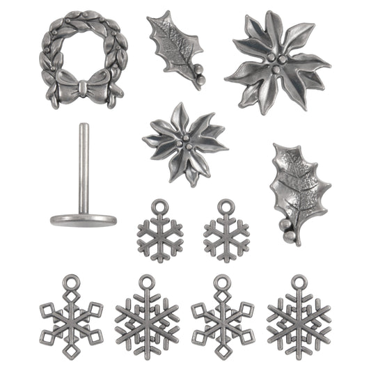 photo of Christmas Noel Charms and Stand ... Idea-Ology Metal Adornments by Tim Holtz. Beautifully detailed bright silver coloured metal miniature pieces to use as embellishments for display makes, mixed media, paper crafts, card making, papercrafts, scrapbooking and visual creative arts. 12 (twelve) pieces.
Tim Holtz Idea-Ology Metal Adornments include holly, poinsettia flowers, snowflakes in 2 sizes, a wreath with a stand.  TH94445