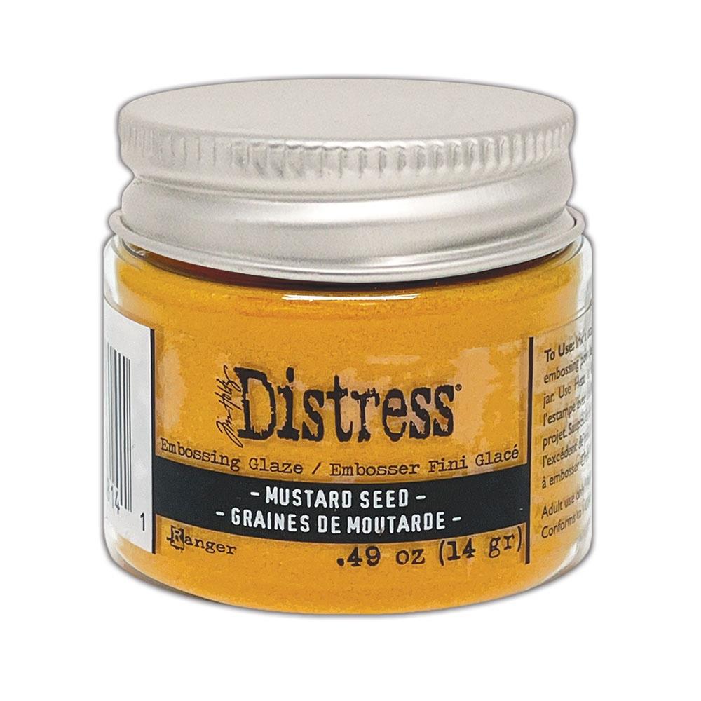 Mustard Seed Distress Embossing Glaze by Tim Holtz and Ranger. Distress Embossing Glaze is a fine embossing powder that once melted with a heat tool, creates a colourful tinted semi translucent and slightly textured glazing effect (like a varnish or enamel). Ideal for lettering, stamped images, stenciled areas, abstracts, backgrounds, cardmaking, mixed media, visual arts. Layer over other Distress inks, paints and stains for an unlimited colour palette.