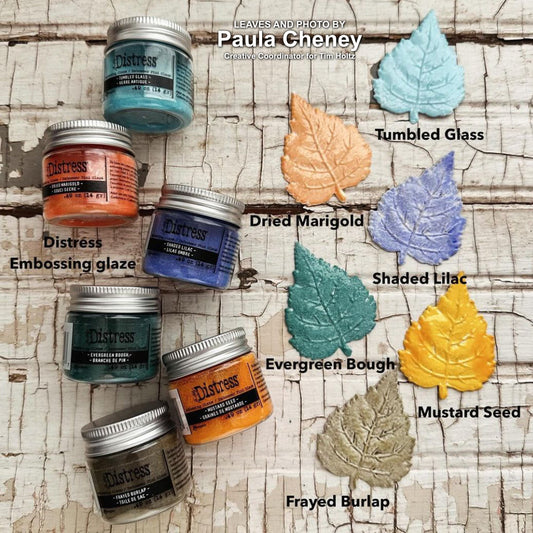 Distress Embossing Glaze by Tim Holtz and Ranger. Distress Embossing Glaze is a fine embossing powder that once melted with a heat tool, creates a colourful tinted semi translucent and slightly textured glazing effect (like a varnish or enamel). Ideal for lettering, stamped images, stenciled areas, abstracts, backgrounds, cardmaking, mixed media, visual arts. Layer over other Distress inks, paints and stains for an unlimited colour palette. Photo by Paula Cheney of 6 new colours, sept 2024.