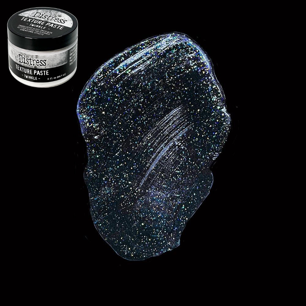 Twinkle - Texture Paste, Translucent, Shimmery and Shiny - Tim Holtz Distress dimensional medium with clear coverage, sparkly glittery highlights and gloss finish, 3fl oz (88.7ml) jar. Made by Ranger. Tim Holtz Distress® Texture Paste Twinkle is a translucent gloss paste with glitter flecks for dimensional effects. The gorgeous Distress Twinkle Texture Paste can be altered and stained to enable endless colourful possibilities for creativity. Photo on black.