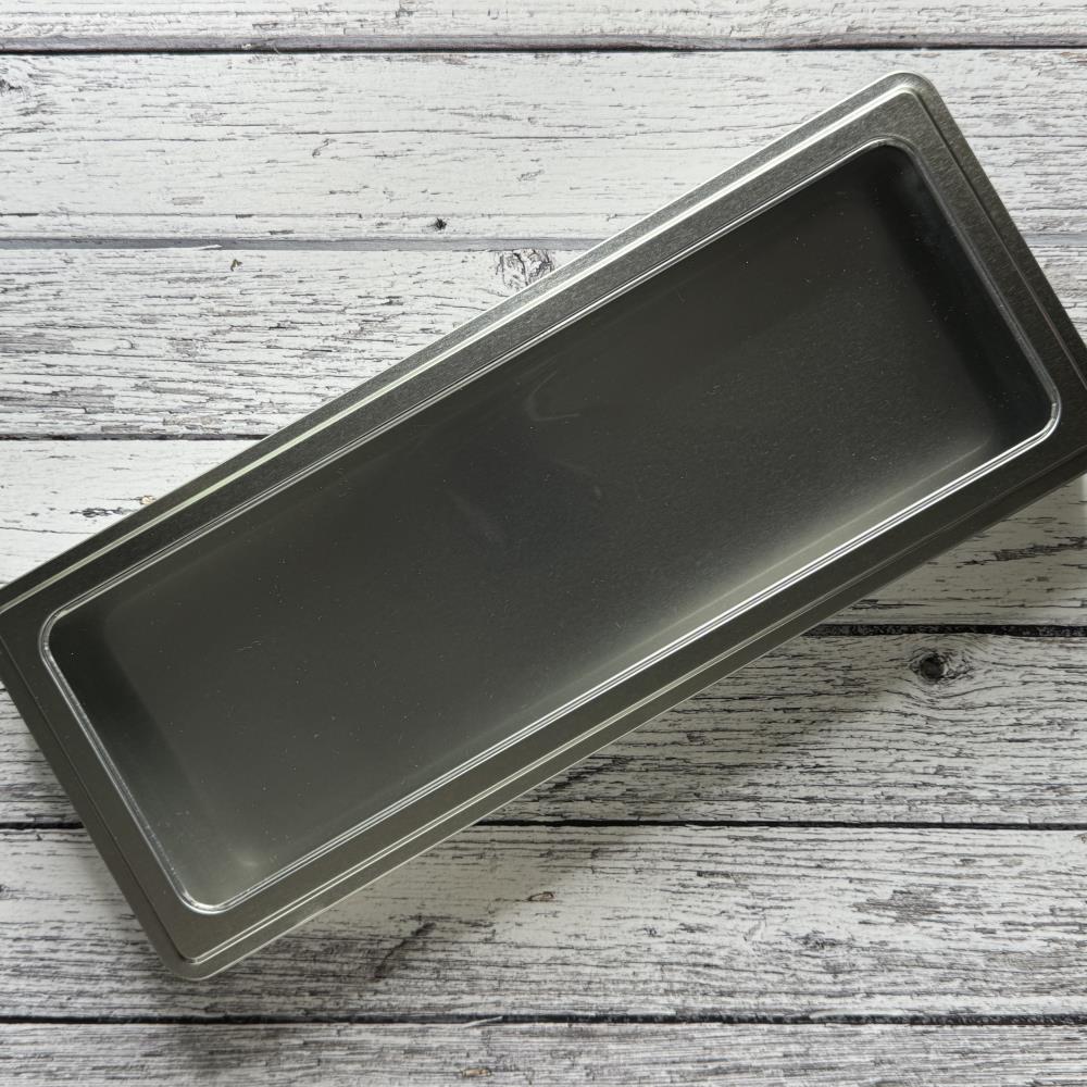 Spritz Distress Storage Tin ... by Tim Holtz and Ranger - 1 (one) empty metal container with hinged lid and window. Designed to fit 12 (twelve) bottles of Distress Spritz Sprays (sold separately). Organise and transport your Distress essentials and other arty treasures easily in this convenient stylish lightweight container. Features a clear window on a hinged lid which has a snug closure to keep it closed during transit. Photo of a closed Distress Spritz Tin.