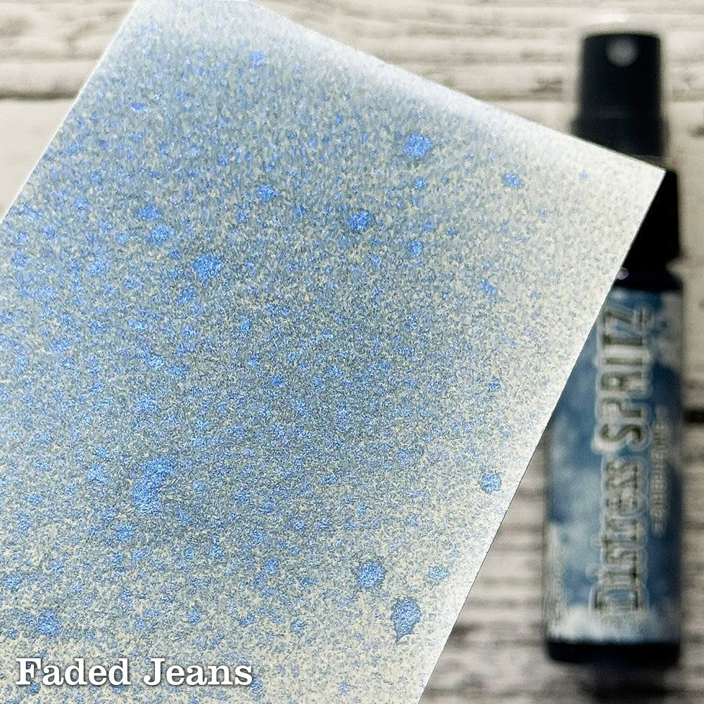 Faded Jeans - Distress Spritz by Tim Holtz and Ranger - a pearlised fusion of colourful mica pigment and clear medium to easily create a gorgeous shimmery splattery effect on artwork in colours that compliment the whole Distress rainbow. Each bottle contains 1 fl oz (29ml) with a fine spritzing nozzle and easy to hold container. Use Tim Holtz Distress Spritz for mixed media, scrapbooking, paper crafts, card making, junk journals and visual arts. Photo is a sample by Ranger.