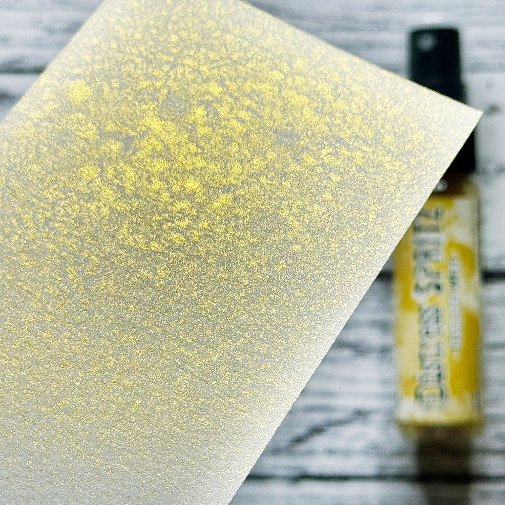 swatch of Fossilized Amber - Distress Spritz ... by Tim Holtz and Ranger - a pearlized Distress ink fusion of colourful mica pigment and clear medium to create a shimmery splattery effect on paper and card surfaces. Each bottle contains 1 fl oz (29ml) with a fine sprayer nozzle and easy to hold container. Enjoy adding Distress Spritz shimmery effects with cardmaking, scrapbooking, mixed media and journaling.