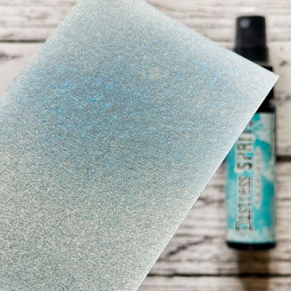 swatch of Peacock Feathers - Distress Spritz ... by Tim Holtz and Ranger - a pearlized Distress ink fusion of colourful mica pigment and clear medium to create a shimmery splattery effect on paper and card surfaces. Each bottle contains 1 fl oz (29ml) with a fine sprayer nozzle and easy to hold container. Enjoy adding Distress Spritz shimmery effects with cardmaking, scrapbooking, mixed media and journaling.