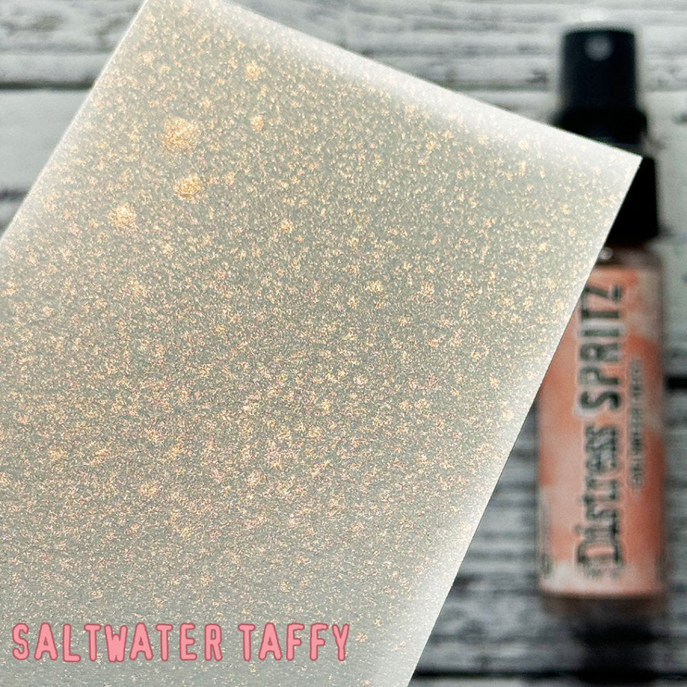 Saltwater Taffy - Distress Spritz by Tim Holtz and Ranger - a pearlised fusion of colourful mica pigment and clear medium to easily create a gorgeous shimmery splattery effect on artwork in colours that compliment the whole Distress rainbow. Each bottle contains 1 fl oz (29ml) with a fine spritzing nozzle and easy to hold container. Use Tim Holtz Distress Spritz for mixed media, scrapbooking, papercrafts, cardmaking, junk journals and visual arts. Photo is a sample by Ranger.