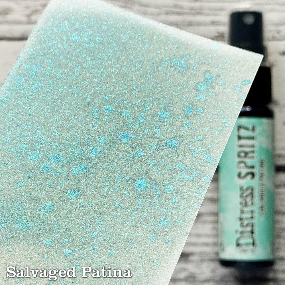 Salvaged Patina - Distress Spritz by Tim Holtz and Ranger - a pearlised fusion of colourful mica pigment and clear medium to easily create a gorgeous shimmery splattery effect on artwork in colours that compliment the whole Distress rainbow. Each bottle contains 1 fl oz (29ml) with a fine spritzing nozzle and easy to hold container. Use Tim Holtz Distress Spritz for mixed media, scrapbooking, paper crafts, card making, junk journals and visual arts. Photo is a sample by Ranger.