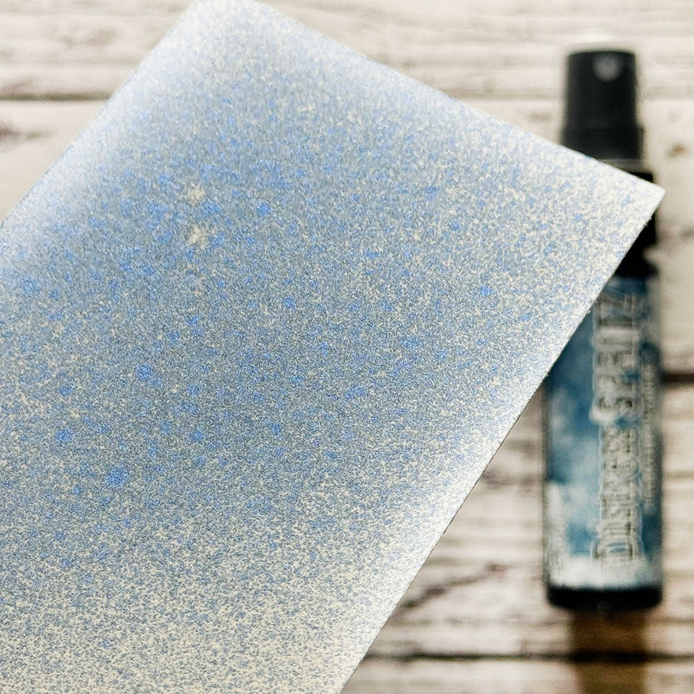 swatch of blue, Uncharted Mariner - Distress Spritz ... by Tim Holtz and Ranger - a pearlized Distress ink fusion of colourful mica pigment and clear medium to create a shimmery splattery effect on paper and card surfaces. Each bottle contains 1 fl oz (29ml) with a fine sprayer nozzle and easy to hold container. Enjoy adding Distress Spritz shimmery effects with cardmaking, scrapbooking, mixed media and journaling.