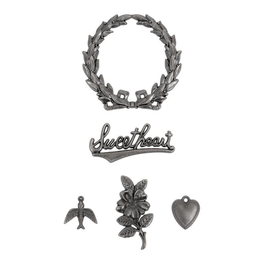 Sweetheart ... Idea-Ology Adornments by Tim Holtz. 5 (five) pieces, made of metal to use for mixed media, decorating ornaments, home decor makes and visual arts. Tim Holtz Idea-Ology Metal Adornments are finished in an antique style pewter colour. TH94363. Sizes (approx) : wreath is 50mm x 50mm, 'sweetheart' is 42mm wide, heart is 13mm x 16mm (incl loop), flower is 18mm x 37mm, flying bird is 17mm x 17mm (incl loop).