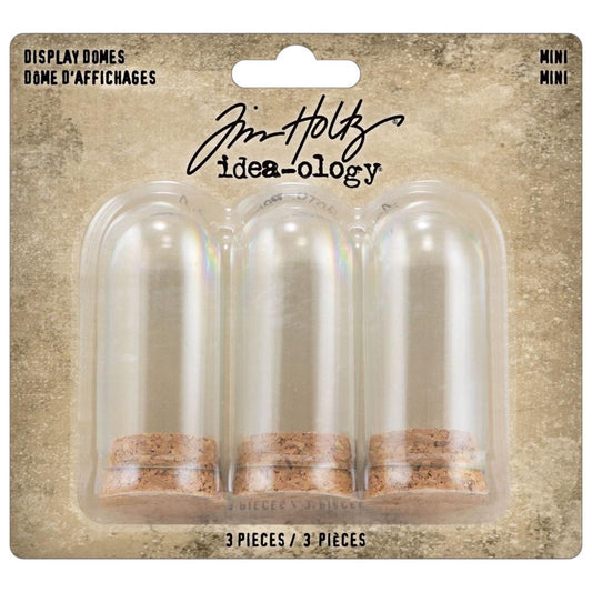 Glass Display Domes, Mini, with Cork Bases ... by Tim Holtz Idea-Ology - Use for mixed media, assemblage projects, off-the-page marvels and party decor. Pack of 3 (three) tall narrow glass displays with domed shape and natural cork bases. Size is 25mm x 50mm tall, plus the height of the corks. Add to your project, off-the-page marvel, canvas or other artistic creation and attach using trimmings, fasteners or collage medium. Alter using alcohol inks, texture pastes, Distress crayons or Distress paints.