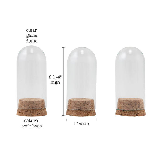 Glass Display Domes, Mini, with Cork Bases ... by Tim Holtz Idea-Ology - Use for mixed media, assemblage projects, off-the-page marvels and party decor. Pack of 3 (three) tall narrow glass displays with domed shape and natural cork bases. Size is 25mm x 50mm tall, plus the height of the corks. Add to your project, off-the-page marvel, canvas or other artistic creation and attach using trimmings, fasteners or collage medium. Alter using alcohol inks, texture pastes, Distress crayons or Distress paints.