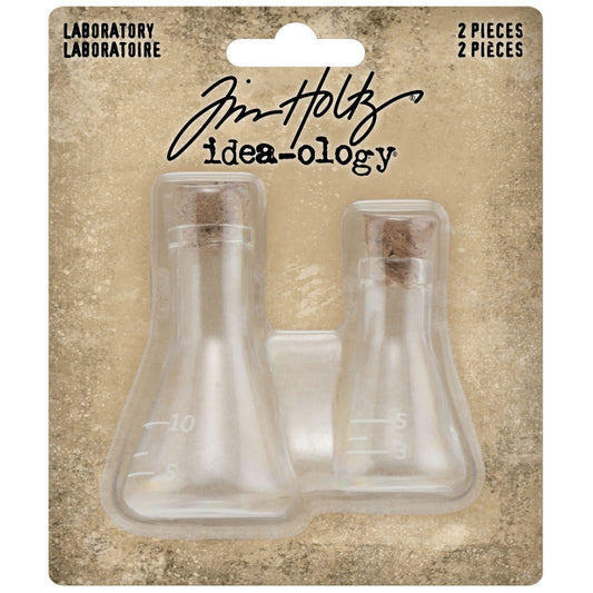 Laboratory Glass Flasks with Corks ... by Tim Holtz Idea-Ology - Use for mixed media, assemblage projects, off-the-page marvels and party decor. Pack of 2 (two) triangular shaped glass bottles with cork lids. Sizes are 24mm x 42mm tall and 30mm x 54mm tall, plus the height of the little corks. One of each size. Add to your project, off-the-page marvel, canvas or other artistic creation and attach using trimmings, fasteners or collage medium. TH94144