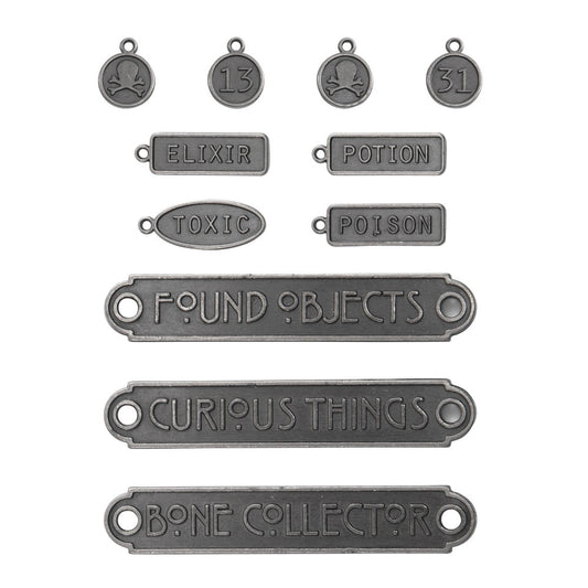 Word Plaques and Tags ... Idea-Ology Metal Adornments by Tim Holtz ... variety of symbols and words on little metal pewter (polished antique silver) coloured tags (round, rectangle, oval) and plaques (long banners) to use with mixed media, cardmaking, papercraft, scrapbooking and visual arts. 11 (eleven) designs (one of each). Sizes from 6mm wide to 60mm wide.