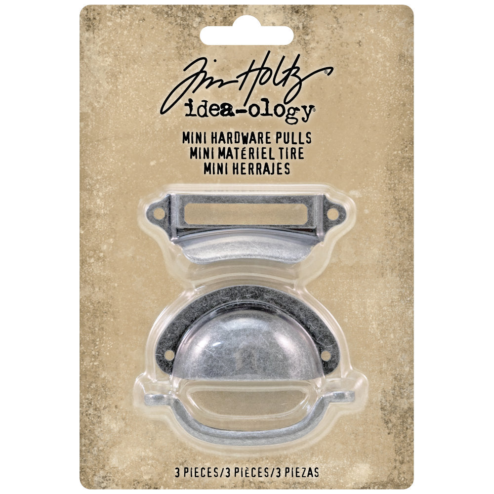 Mini Hardware Pulls ... Idea-Ology by Tim Holtz ... beautifully crafted and durable, these metal handles are small versions of the real thing, perfect for boxes, trays, panels, drawers, cupboards, book covers, as decoration or as handles. Pack of 3 (three) pieces, one of each style in a silver colour. TH93685 . Inspired by real handles from antique and vintage drawers, file cabinets and cupboards, these metal hardware pulls are ideal to use for both visual arts and small furniture making. Photo of packaging