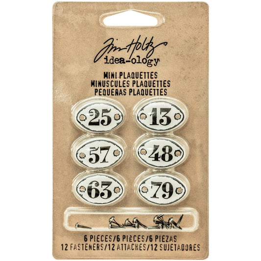 Mini Plaquettes (with fasteners) ... Idea-Ology Adornments by Tim Holtz. Oval plaques with black numerals on white enamel background with predrilled holes for attaching to mixed media, decorating ornaments, home decor makes and visual arts of all kinds. 6 (six) plaques (one of each) 3/4" x 1/2" in size, 12 (twelve) metal split pins (brads, tiny screw-top fasteners).