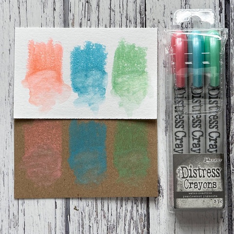 Distress Pearlescent Crayons - Christmas Set 6 ... by Tim Holtz... Limited Edition, seasonal colours of pearlescent shimmery pigment mica fusion in a solid watersoluble crayon in a twist-style barrel with lid. This set has 3 (three) colours (one of each) - Sugary Gumdrop, Wonderland, Frosty Mint.   Tim Holtz Distress Mica Pearl Crayons in these seasonal colours add beautiful pearlescent colourful layers to your artwork. 