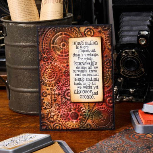 Gears - Texture Fades Embossing Folder ... by Tim Holtz and Sizzix (no.666866). Inspired by the industrial steam engine era of handturned cogs and cranks, this easy to use embossing folder creates a wonderful gathering of gears and wires in a background pattern to use with paper, vellum and cardstock. The detailed design creates amazing dimensional texture, ideal for all kinds of papercrafts, pockets, junk journals, scrapbook pages, card backgrounds, anything you wish to make! Photo of a card.