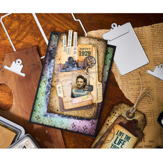 Noteworthy - Sizzix Thinlits die cutting templates by Tim Holtz. 24 (twenty four) assorted labels, tabs, markers, shapes, globe, mini clipboard and a small file folder (no.666876). This set of Thinlits and Framelits include designs that will enable you create a fantastic variety of envelopes, tags, labels, banners, tickets, stationery pieces, journal fodder, junk journal pages, scrapbooking elements and much more.  Photo of an example of what to make.