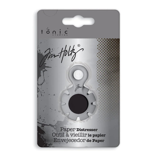 Paper Distresser - by Tim Holtz and Tonic Studios ... this is a tool for roughing up paper, cardstock edges and cutting threads in papercrafts, mixed media and tactile crafts. Includes a Kushgrip holder, hanging loop and 7 sharp recessed edges. Ergonomic Kushgrip round centre spot for comfort during handling, with very sharp steel blades recessed within the grey round plastic surround. It is safe to hold and easy to use. Photo from Tonic Studios of packaging.
