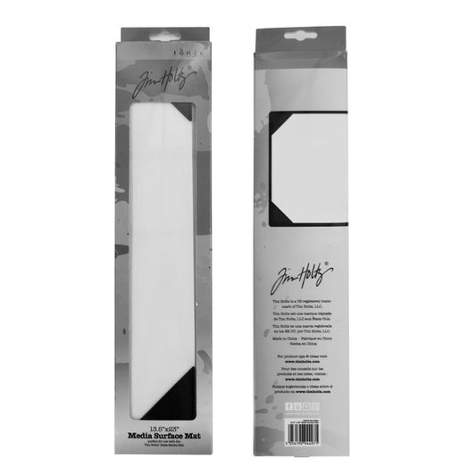 Media Surface Mat - by Tim Holtz and Tonic Studios ... Full Size 23" x 13.5" heavy duty, non stick and heat resistant craft workspace with weighted reinforced corners ... use as a stand alone craft mat for wet and dry techniques or use with Tim's large Glass Media Mats (also available, sold separately). Photo of the packaging, back and front.