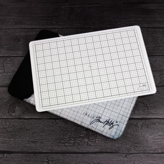 White Travel Sized Glass Media Mat with Padded Storage Pouch - by Tim Holtz and Tonic Studio ... A portable white tempered glass mat with gridlines, silicon feet with both metric and imperial measurements. Overall size is 10 1/4" x 15 3/4" (26cm x 40cm). Tim Holtz and Tonic Studio have made for you, this fantastic multi-functional tool ideal for creating and crafting in your workspace, whether in a studio, craft corner at home, travelling on holidays or during lunch at the office. Everywhere :)