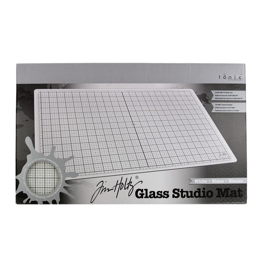 White Studio Glass Media Mat - Large Creative Surface 14"x23" ... by Tim Holtz and Tonic Studios. Tempered white glass mat with gridlines, silicon feet with both metric and imperial measurements.
Tim Holtz and Tonic Studio have made for you, this fantastic multi-functional tool for creating and crafting in your workspace, whether in a studio, craft corner at home or during lunch at the office ... it is stylish and practical.