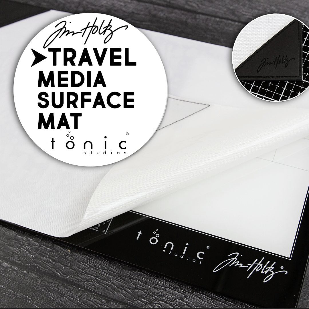 Small (Travel Sized) Media Surface Mat by Tim Holtz and Tonic Studios ... Travel Sized 15.5" x 10" heavy duty, non stick and heat resistant craft workspace with weighted reinforced corners ... designed to use as a stand alone craft mat or with Tim's Travel Sized Glass Media Mats (all sizes also available, each sold separately) as well as on its own. Photo of the glass mat with notes.