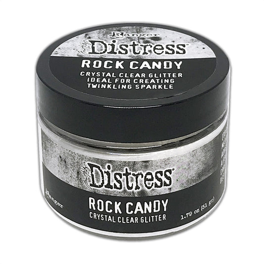 Distress Dry Glitter, Rock Candy - by Tim Holtz. A crystal clear, light sparkly dusting of glitter in a 1.79oz, 51g jar with wide opening lid. This jar of dry very fine and sparkly glitter is beautiful to look at, easy to work with and simple to clean up. Being a clear glitter, it can be used to enhance the colour of your artwork, or altered with Distress inks, watercolour paints and other pigments and colours.