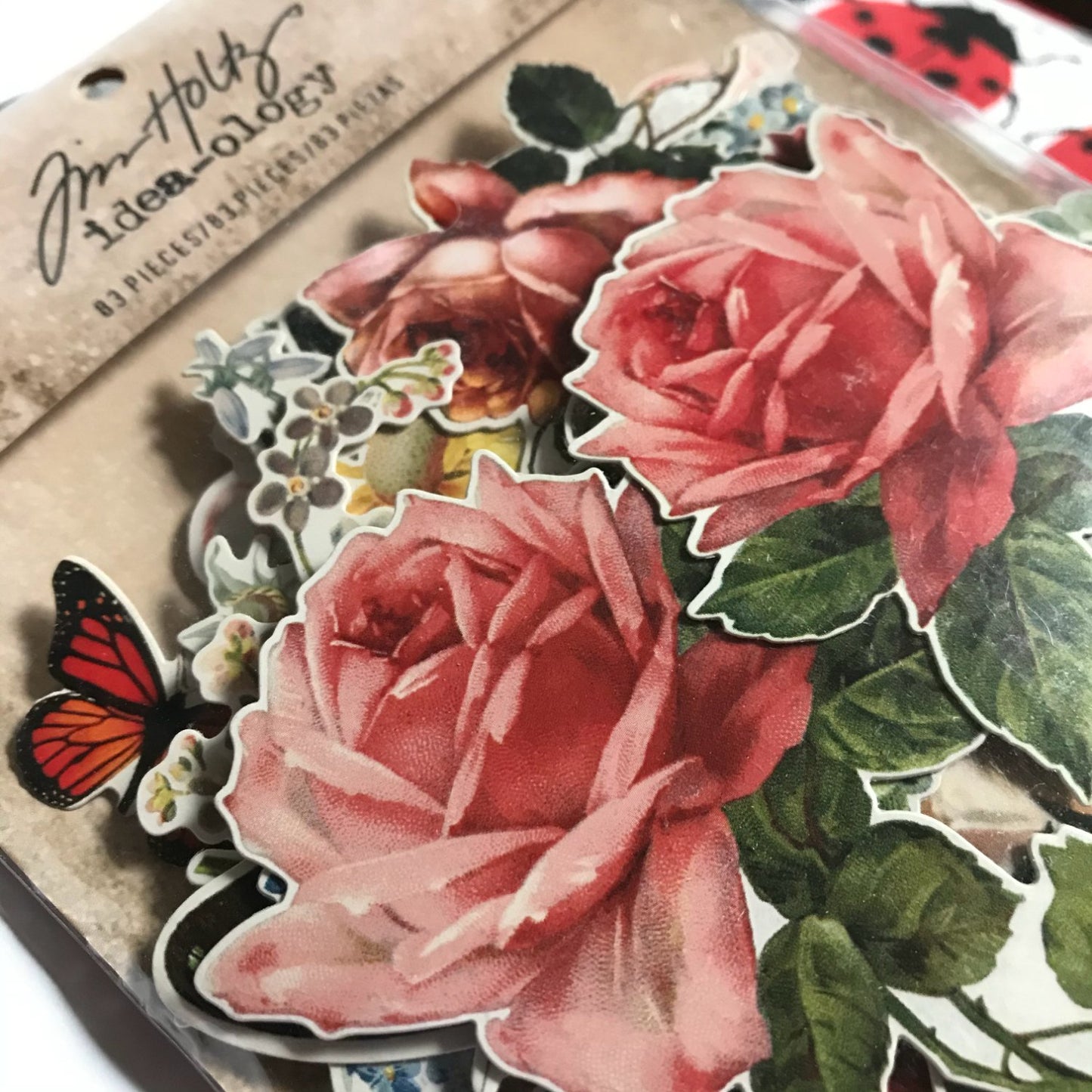 Botanical - Idea-Ology Layers ... by Tim Holtz ... over 80 gorgeous images die cut, ready to use. Made of thin durable cardstock with a satin finish. Over 80 assorted die-cut pieces, neatly trimmed out of quality cardstock with only a fraction of a white border around the image. Ready to use at a moment's notice. Designs include beautiful vintage illustrations of roses, blooms, daisies, bouquets, posies and single flowers with a variety of butterflies in different sizes, colours and species.