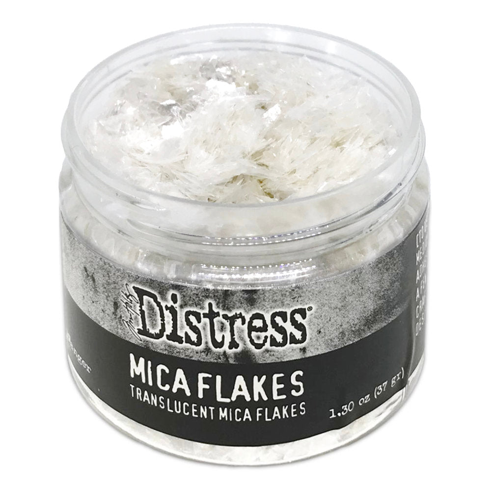 Mica Flakes ... by Tim Holtz Distress - translucent (clear) white pearl mica flakes, 1.3 oz (37 gram) wide opening jar. This jar of shimmery Mica Flakes is beautiful to look at, easy to work with and simple to clean up. These beautiful clear and clean Distress Mica Flakes are soft and light.