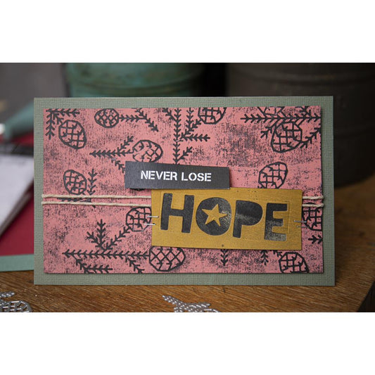 example of an imprint on a card made using Pine Pattern - Sizzix Thinlits die cutting templates by Tim Holtz. A wonderful selection of modern pine tree foliage and pinecones, 13 pieces (no.666070).