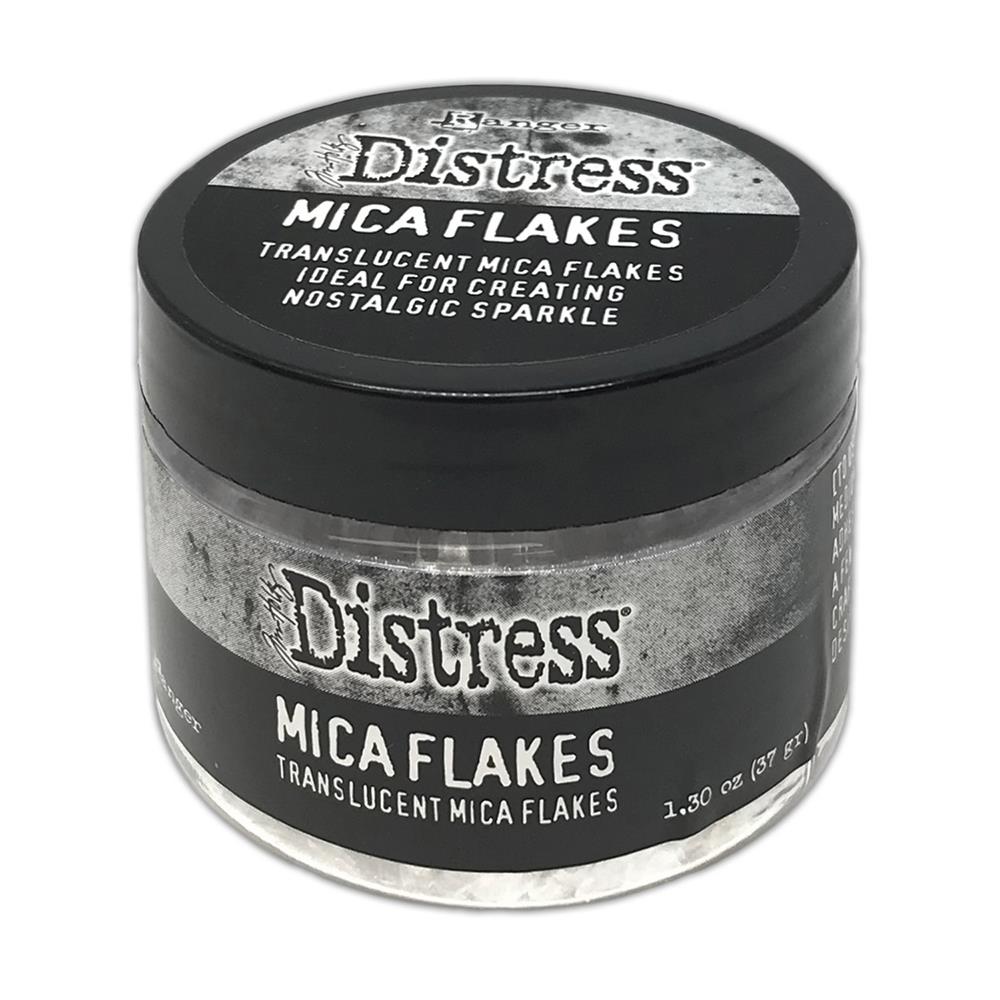 Mica Flakes ... by Tim Holtz Distress - translucent (clear) white pearl mica flakes, 1.3 oz (37 gram) wide opening jar. This jar of shimmery Mica Flakes is beautiful to look at, easy to work with and simple to clean up. These beautiful clear and clean Distress Mica Flakes are soft and light.
