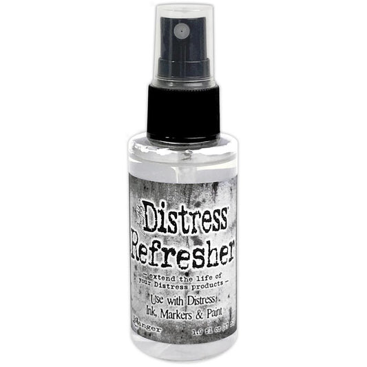 Distress Refresher - in a Spray ... by Tim Holtz. 1.9 fl oz bottle with a sprayer nozzle for reviving Distress Ink Pads and creating faux fabric. 
This useful medium will extend the life of your Distress products by putting moisture back into the Ink Pads and Markers. It can also be used to create faux fabrics from cardstock. Distress Refresher rehydrates and conditions Distress products including ink pads, markers, stains and paints.