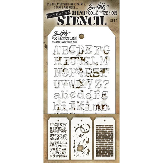 Mini Layering Stencils - set 3 ... by Tim Holtz and Stampers Anonymous. Typo - Splatters - Bricked. Pack of three art stencils (one of each design) for mixed media, papercrafts, scrapbooking and visual arts. Size : overall mask is 8cm x 16cm with a design space of approx 6cm x 12.5cm. Typo features a grunge style alphabet (numerals and letters), Splatters is inspired by stains, water rings and splashes, Bricked is reminiscent of a fence or wall built using old crumbly blocks. Image is the stencils in a pack