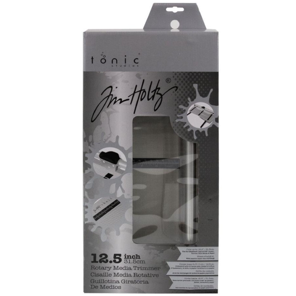 Rotary Trimmer - by Tim Holtz and Tonic Studio - designed with makers in mind for all kinds of papercraft creativity. This essential tool has a 12.5inch cutting length with extendable arms, durable sharp geared rotary blade and ergonomic Kushgrip handle.  Image of product in a box