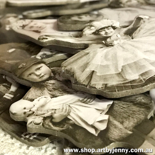 closeup photograph of the Tim Holtz Idea-Ology Baseboard Paper Dolls, embellishments for visual arts