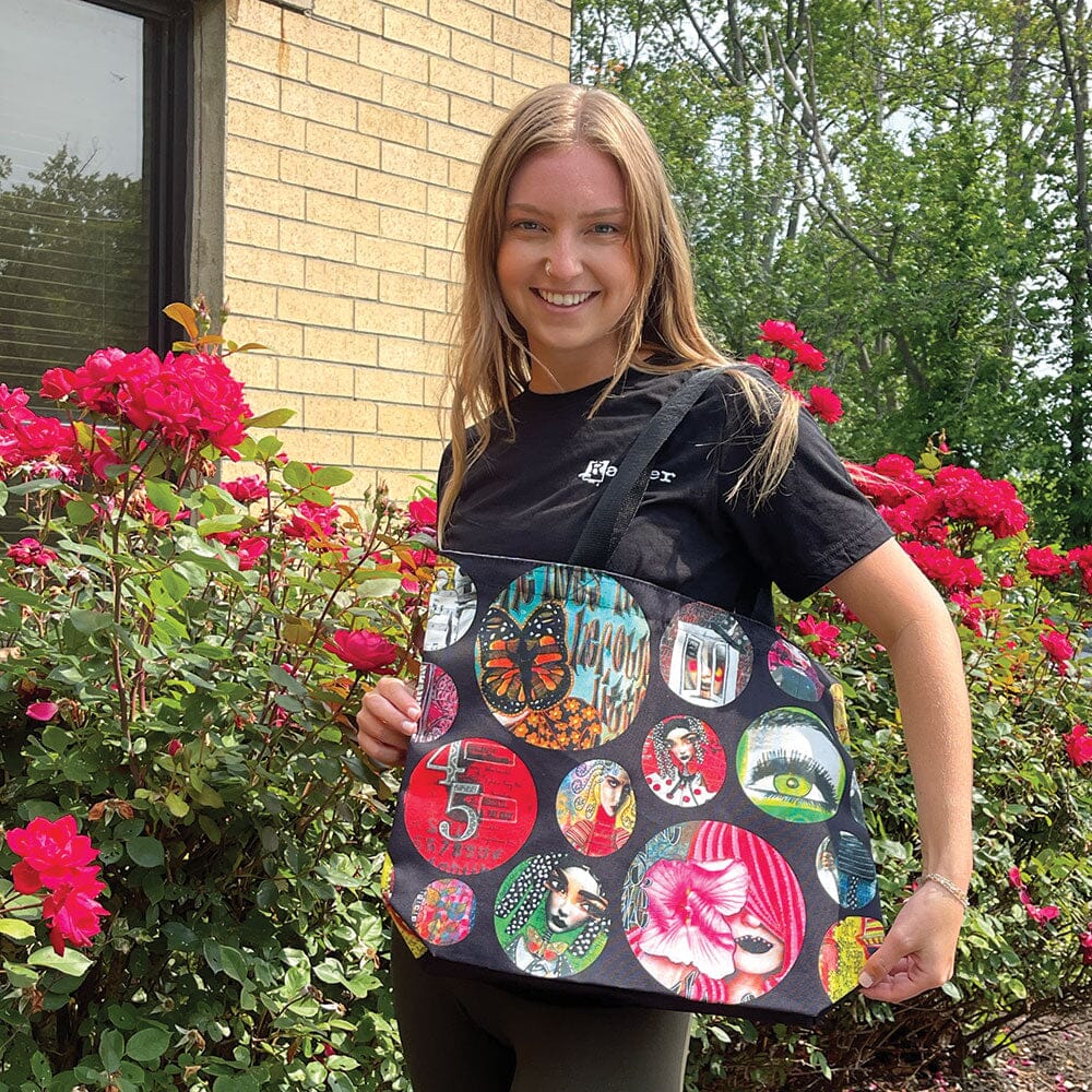 Shoulder Bag, Large Zippered Tote ... by Dyan Reaveley's Dylusions and Ranger. 
Made of the same durable and luxurious feeling printed canvas as used for the Dylusions apron (also available sold separately), this large shoulder bag features a black zipper with silver clasp, long canvas black straps and double stitching for added strength. Perfect carry-all for shopping, carrying art supplies, travelling bag or storage. Photo of the bag being worn by someone from the Ranger family :)