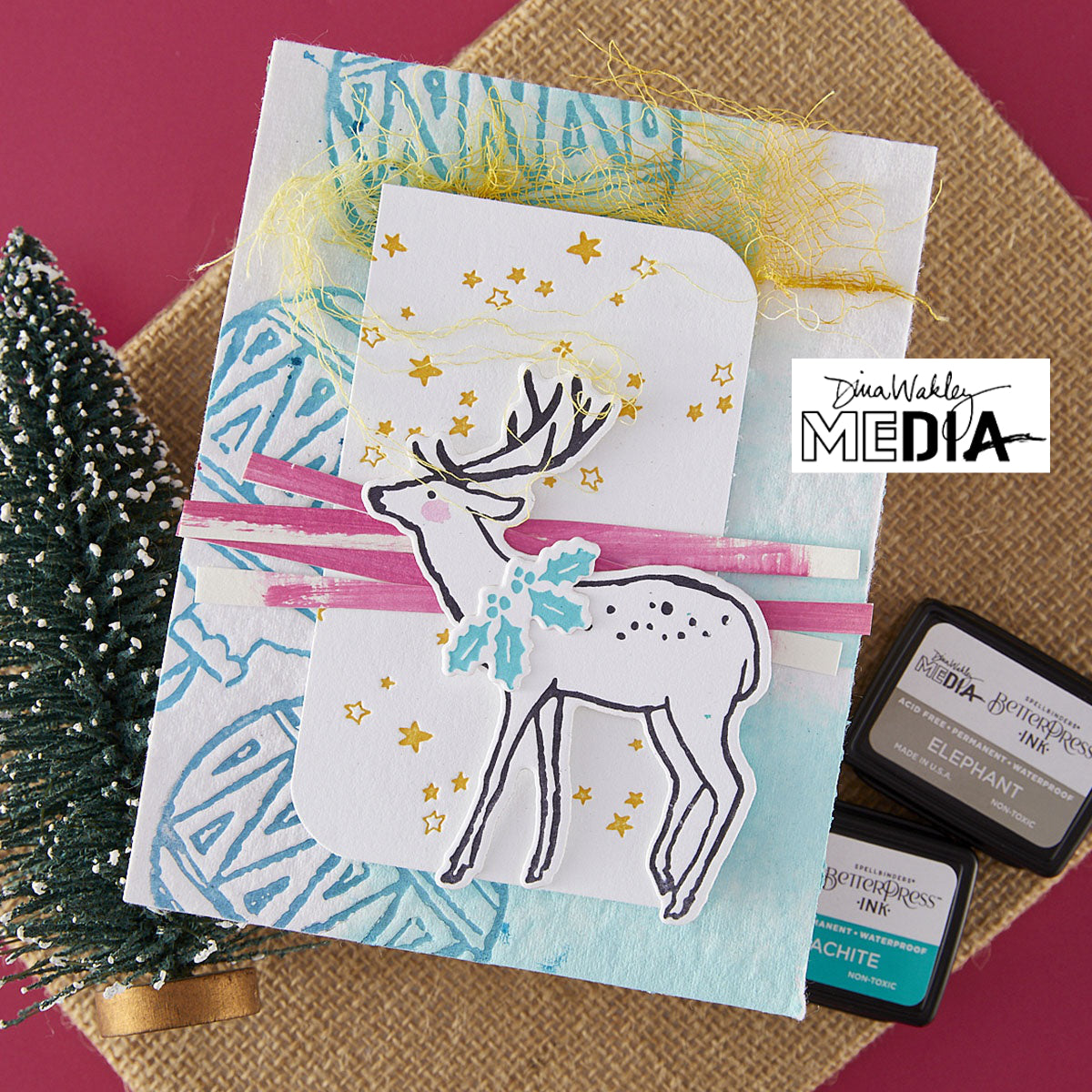 Wonderful Christmas Card made by Dina Wakley using Spellbinder Paper Arts BetterPress Plates and Embossing Folder . Use the designs in mixed media, cardmaking, journaling, scrapbooking and visual arts. Dina's Spellbinders sets include festive designs of birds, baubles, heartfelt messages, holly and berries, spots, crescent moon, reindeer, foliage and stars. All the DWM metal embossing and printing plates can to be used together or separately to create dimension with or without ink. Enjoy!