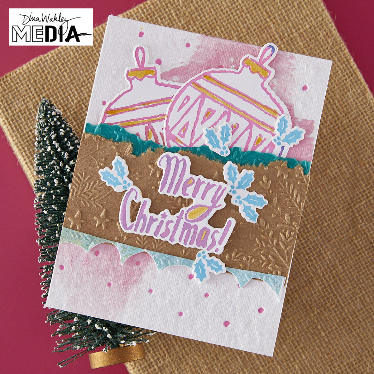 Wonderful Christmas Card made by Dina Wakley using Spellbinder Paper Arts BetterPress Plates and Embossing Folder . Use the designs in mixed media, cardmaking, journaling, scrapbooking and visual arts. Dina's Spellbinders sets include festive designs of birds, baubles, heartfelt messages, holly and berries, spots, crescent moon, reindeer, foliage and stars. All the DWM metal embossing and printing plates can to be used together or separately to create dimension with or without ink. Enjoy!