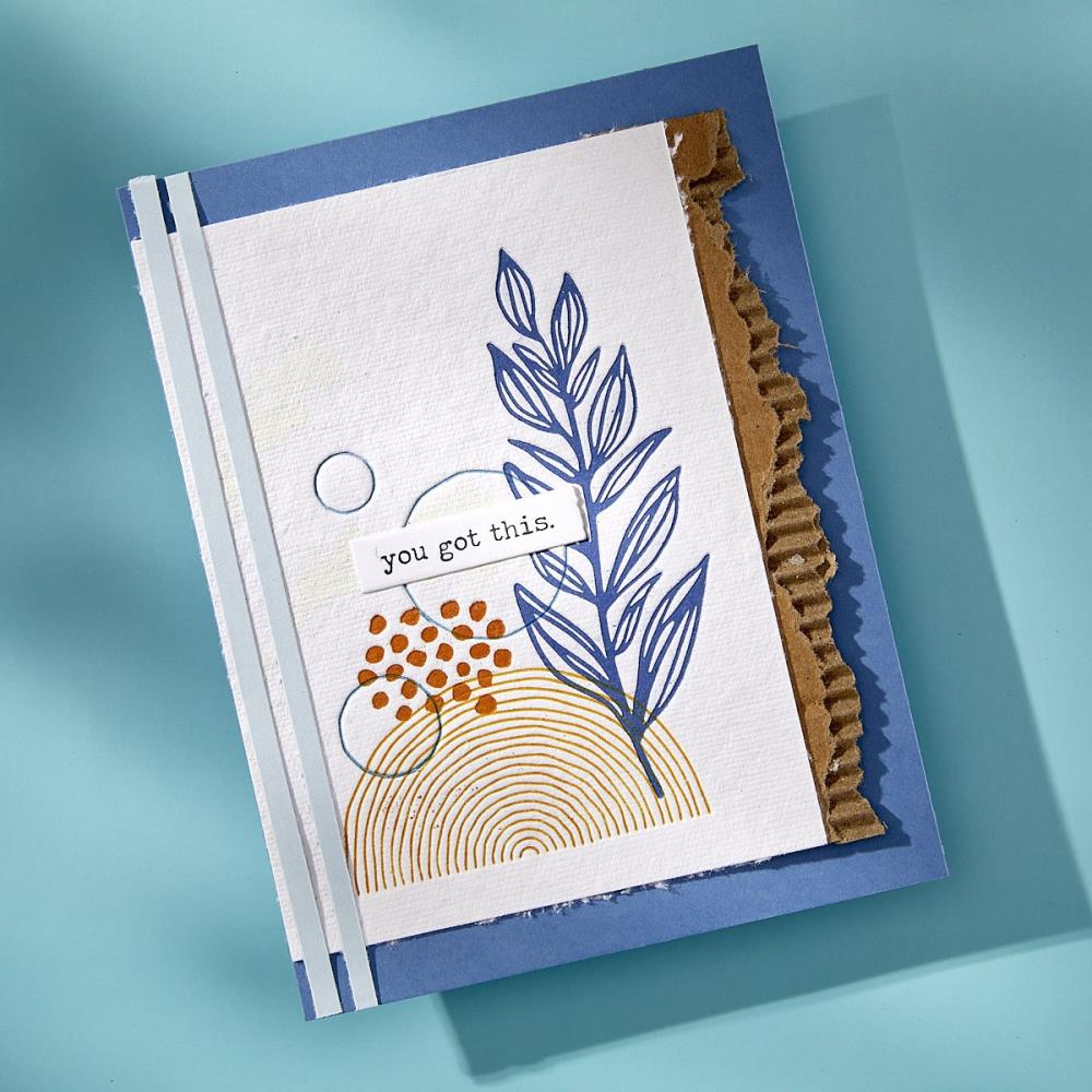 sample created by Dina Wakley using her Spellbinders Paper Arts BetterPress metal plates, dies and embossing folders. Photo shows a greeting card with heartfelt message and blue leaves under a white banner saying, you got this.